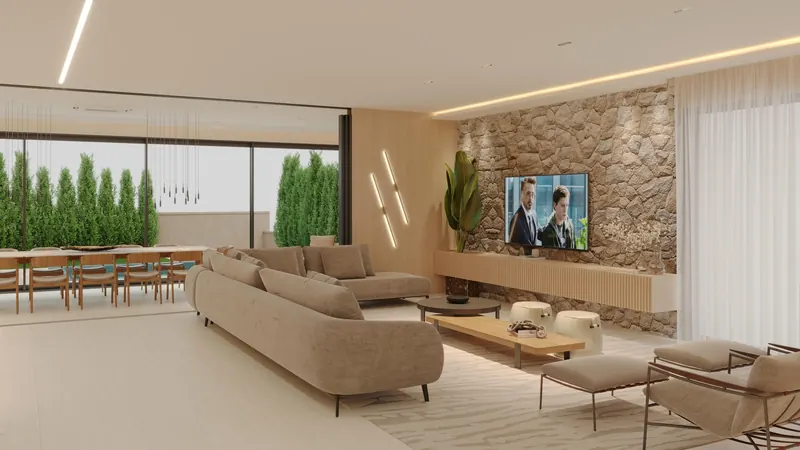 Living integrado com parede de pedra, sofá claro e mesa de jantar longa