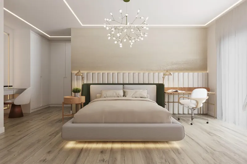 Suíte com cama baixa iluminada, lustre de cristal e painel claro